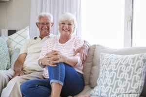 Portrait Of Senior Couple Relaxing On Sofa At Home Together